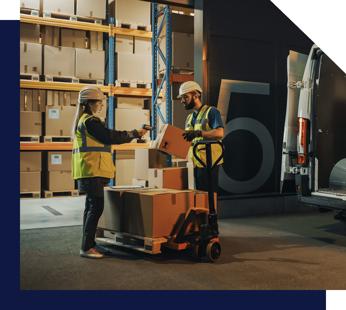 Warehouse workers loading boxes into van.